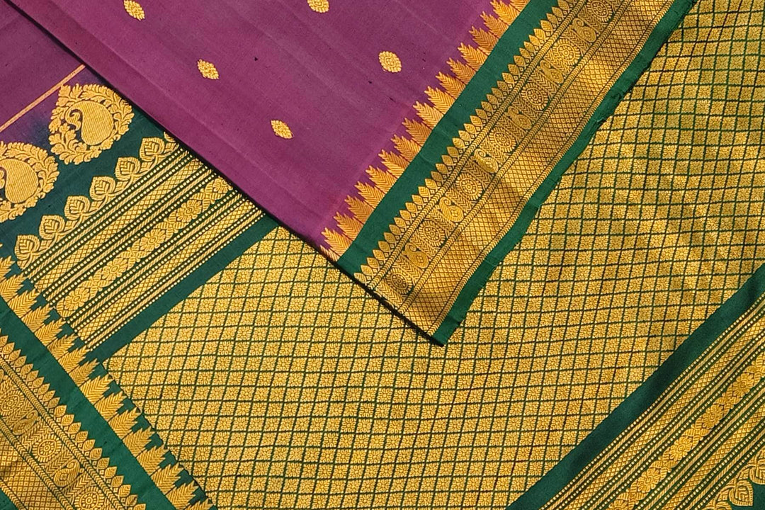 Handwoven Gadwal pure silk saree in  wine with small buttis on the body .