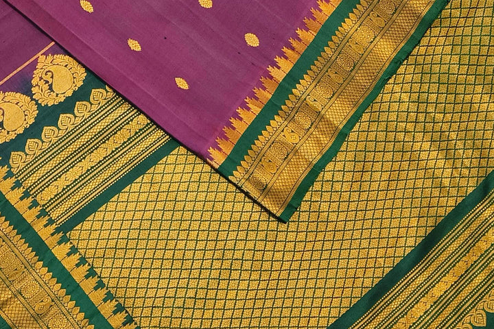 Handwoven Gadwal pure silk saree in  wine with small buttis on the body .