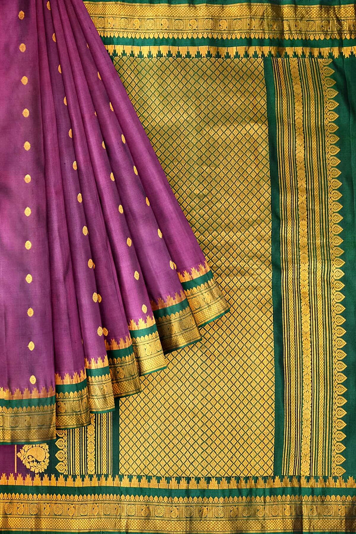 Handwoven Gadwal pure silk saree in  wine with small buttis on the body .