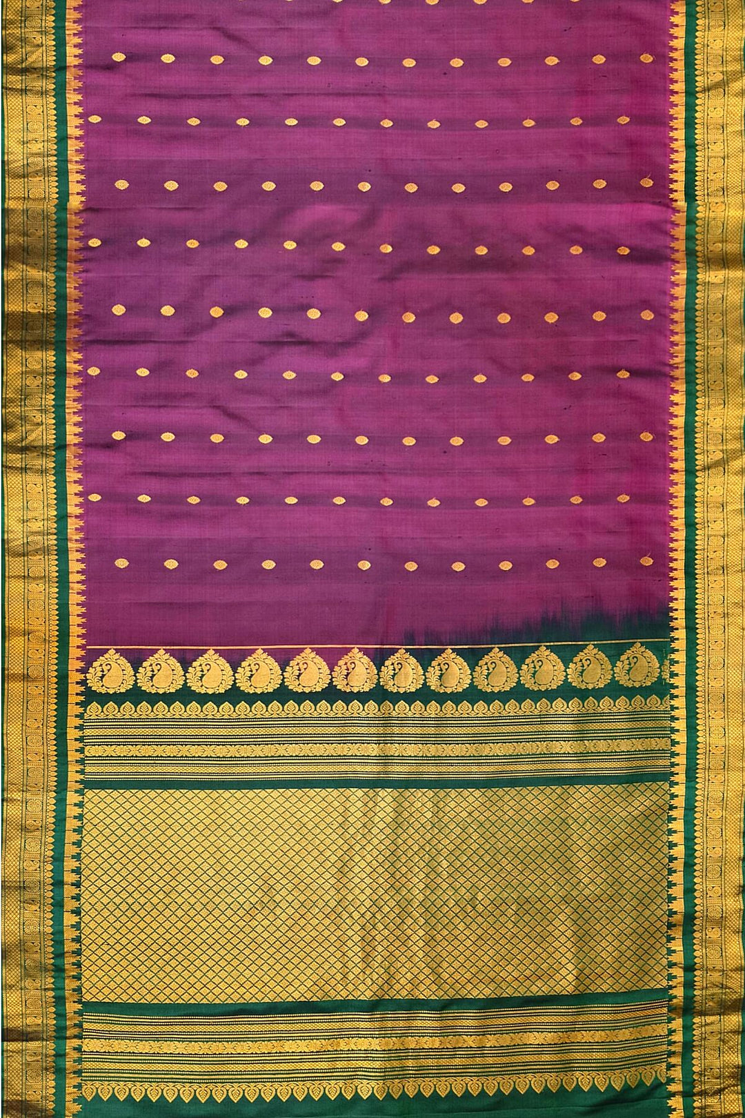 Handwoven Gadwal pure silk saree in  wine with small buttis on the body .