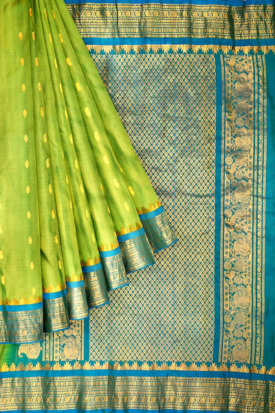 Handwoven Gadwal pure silk saree in  green with small buttis on the body .