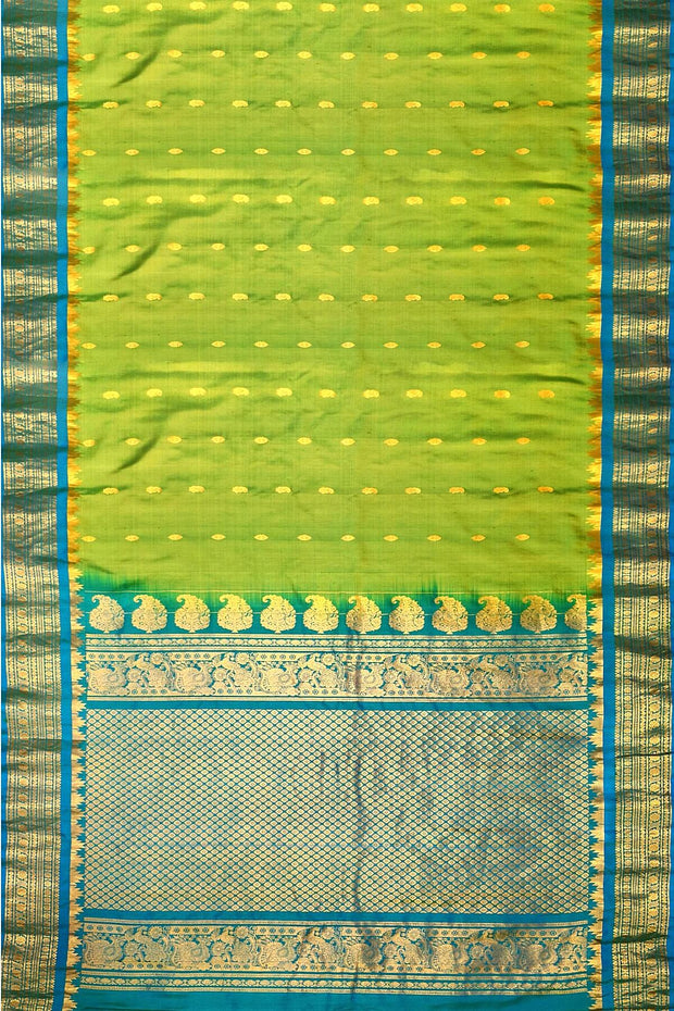 Handwoven Gadwal pure silk saree in  green with small buttis on the body .