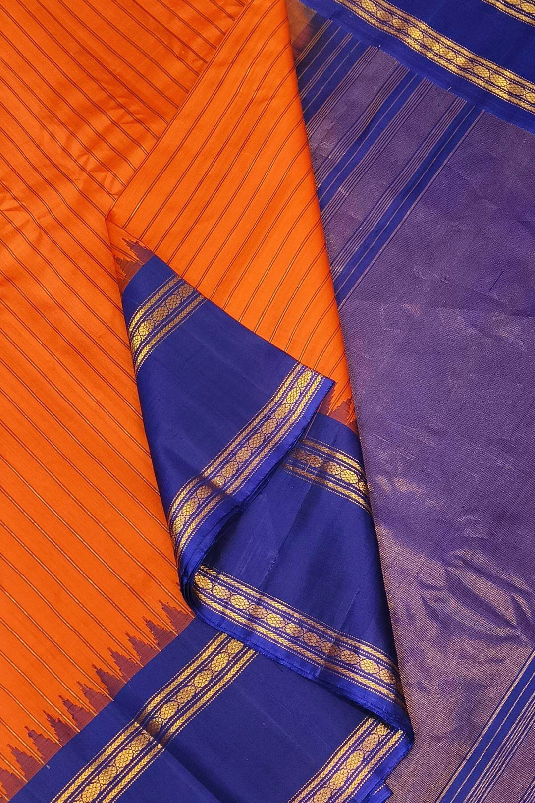 Gadwal pure silk saree in orange with stripes.