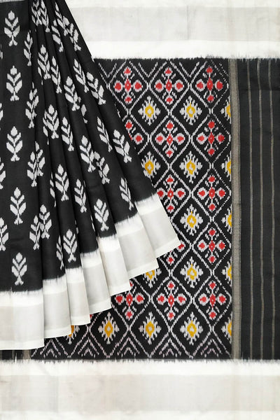 Ikat pure silk saree in black with floral motifs  and silver borders.