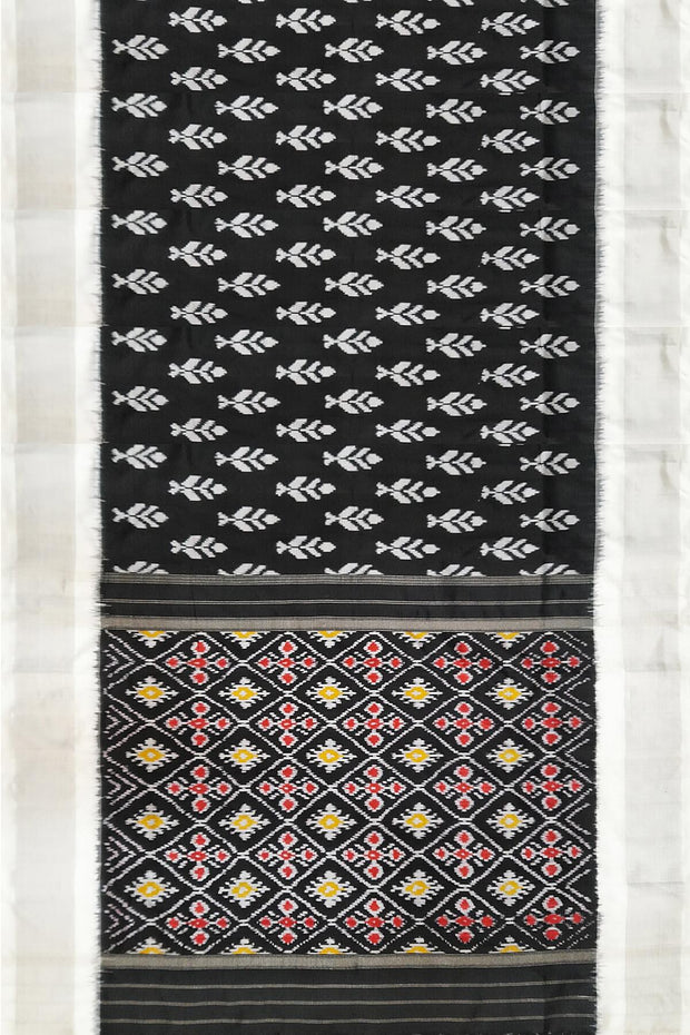 Ikat pure silk saree in black with floral motifs  and silver borders.