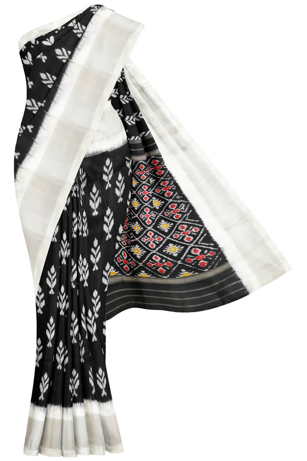 Ikat pure silk saree in black with floral motifs  and silver borders.