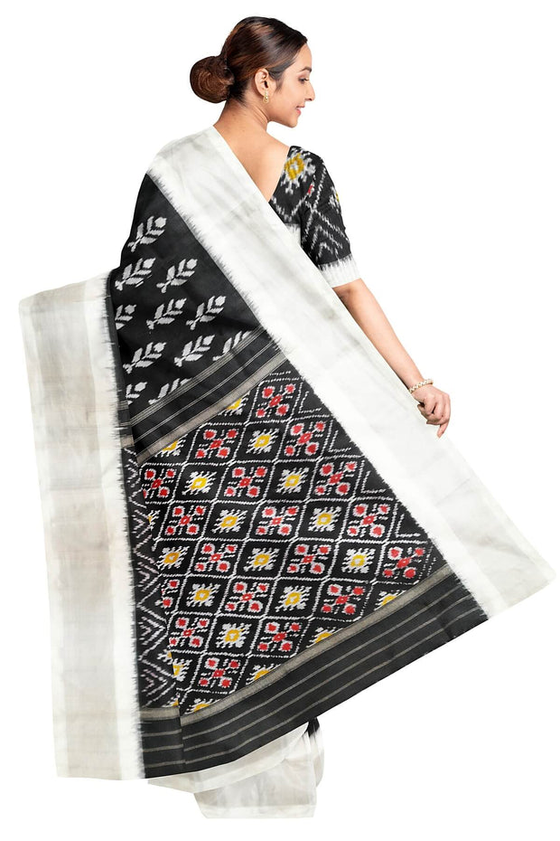 Ikat pure silk saree in black with floral motifs  and silver borders.