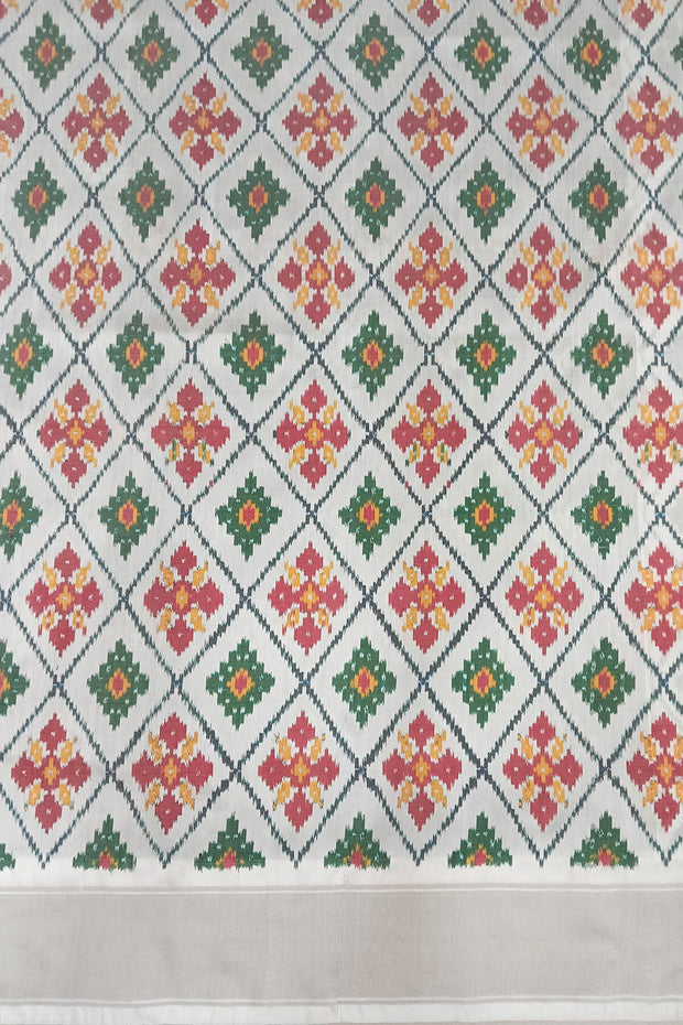 Ikat pure silk sare in dark green in chokta bhat pattern and tissue borders.