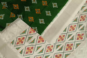 Ikat pure silk sare in dark green in chokta bhat pattern and tissue borders.