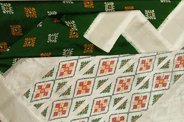 Ikat pure silk sare in dark green in chokta bhat pattern and tissue borders.