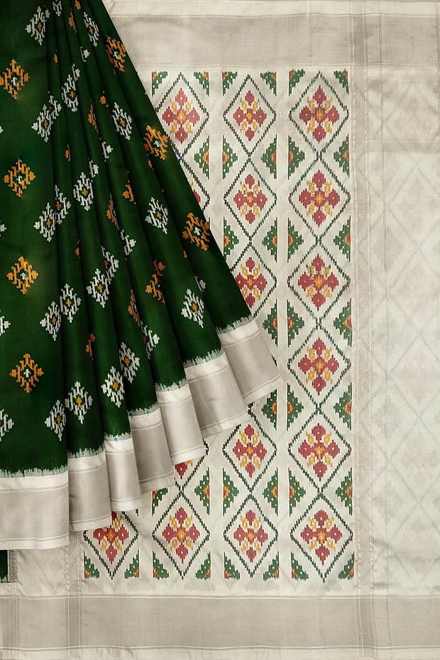 Ikat pure silk sare in dark green in chokta bhat pattern and tissue borders.