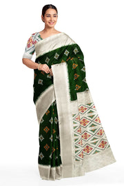 Ikat pure silk sare in dark green in chokta bhat pattern and tissue borders.