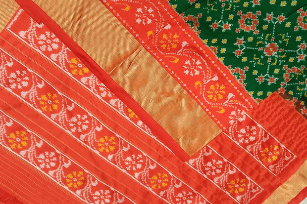 Handwoven Ikat pure silk saree in bottle green in navratan pattern.