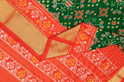 Handwoven Ikat pure silk saree in bottle green in navratan pattern.