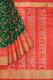 Handwoven Ikat pure silk saree in bottle green in navratan pattern.