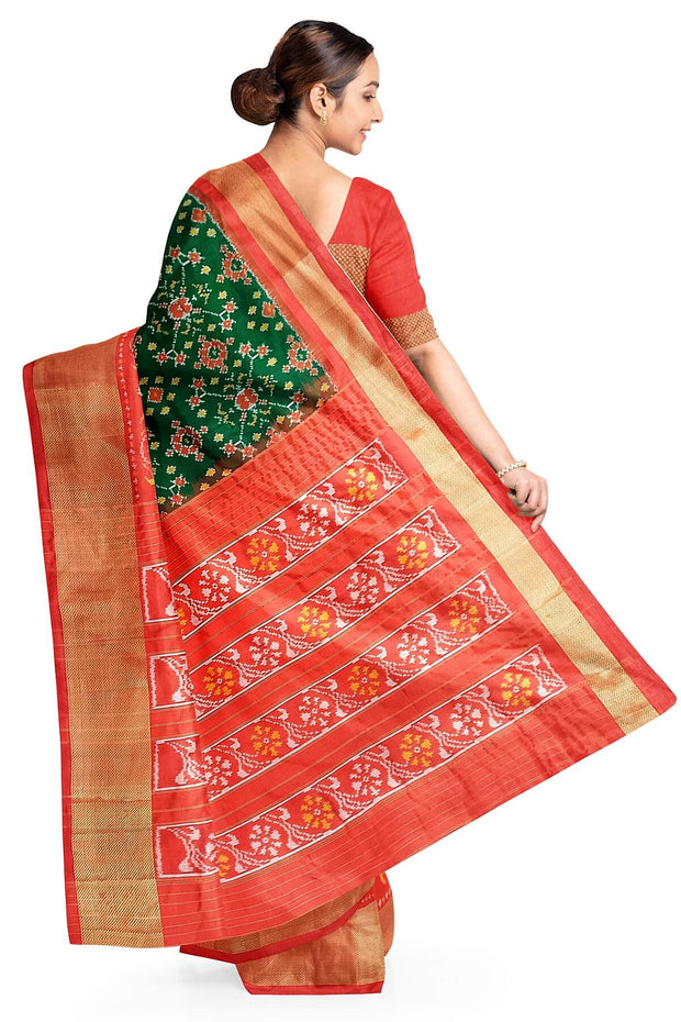 Handwoven Ikat pure silk saree in bottle green in navratan pattern.