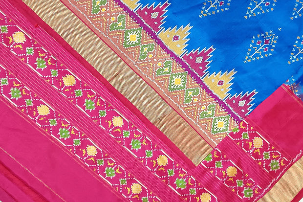 Handowoven ikat pure silk saree  in blue with  floral motifs  and a temple border.