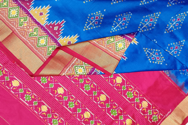 Handowoven ikat pure silk saree  in blue with  floral motifs  and a temple border.