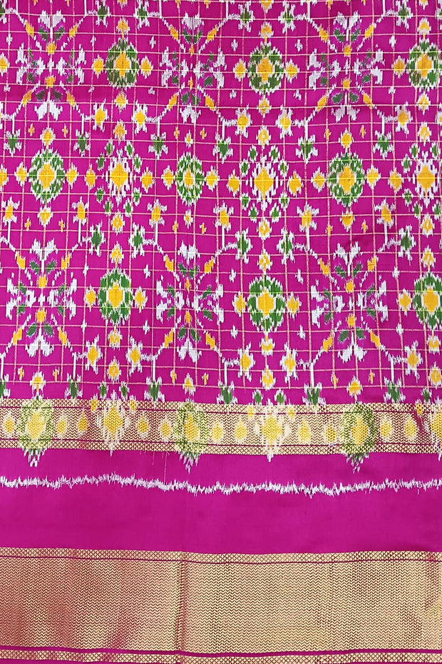 Handwoven ikat pure silk saree in bottle green in fine checks with bird motifs in skirt border .