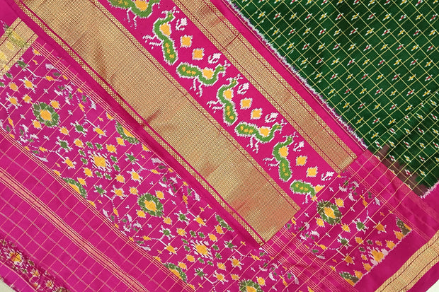 Handwoven ikat pure silk saree in bottle green in fine checks with bird motifs in skirt border .