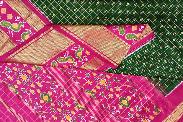 Handwoven ikat pure silk saree in bottle green in fine checks with bird motifs in skirt border .