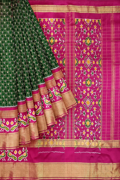 Handwoven ikat pure silk saree in bottle green in fine checks with bird motifs in skirt border .