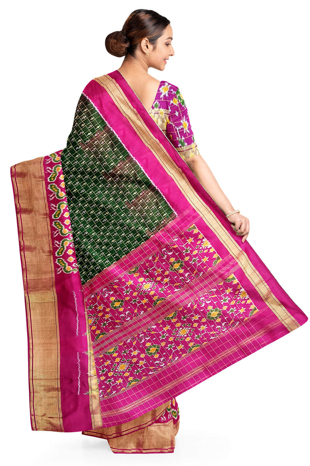 Handwoven ikat pure silk saree in bottle green in fine checks with bird motifs in skirt border .