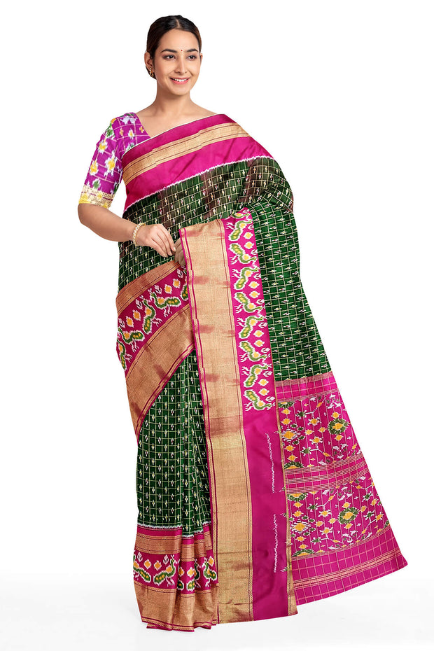 Handwoven ikat pure silk saree in bottle green in fine checks with bird motifs in skirt border .