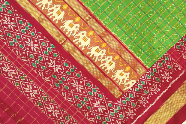 Handwoven ikat pure silk saree in green  in fine checks with elephant motifs in skirt border