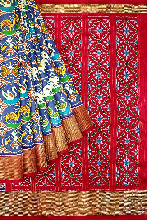 Ikat pure silk saree in double shaded blue with plant & animal pattern on  the body.