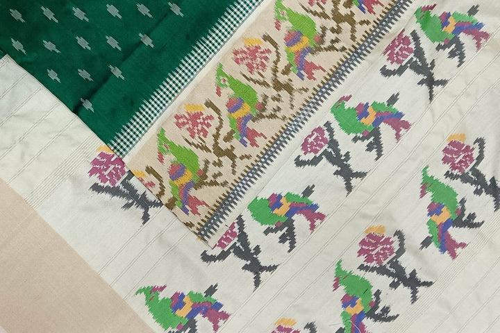 Handwoven ikat pure silk saree in dark green with small motifs