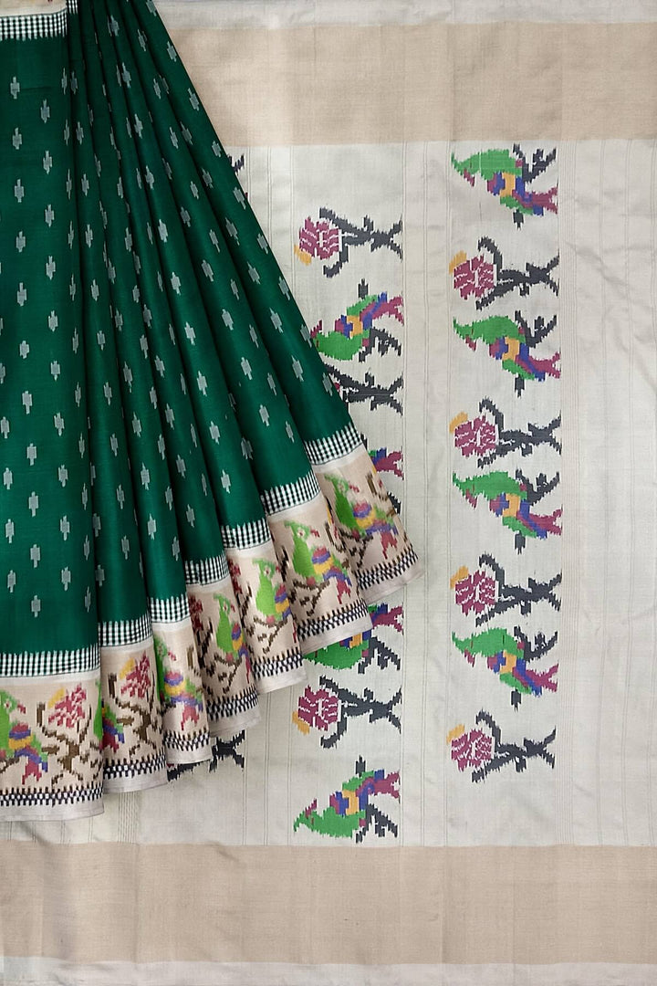 Handwoven ikat pure silk saree in dark green with small motifs