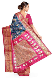 A peacock blue ikat pure silk saree in narikunj pattern with elephant motifs in skirt border.