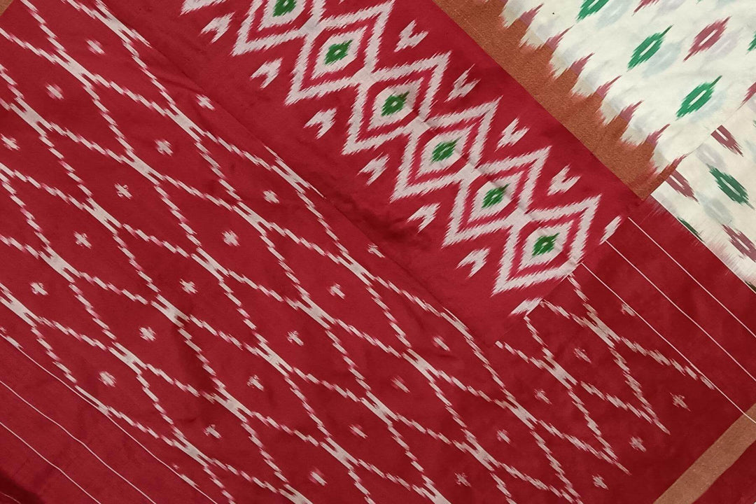 Handwoven ikat pure silk saree in  off white with leaf motifs on the body