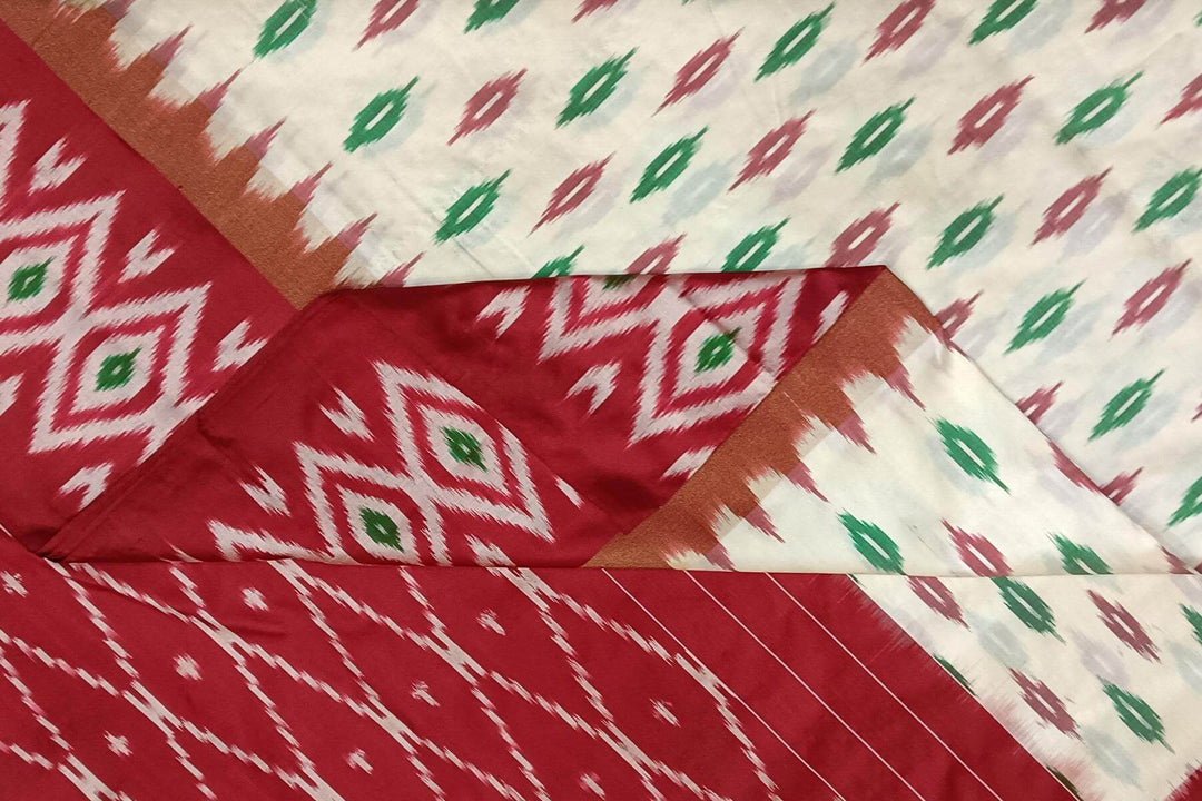 Handwoven ikat pure silk saree in  off white with leaf motifs on the body