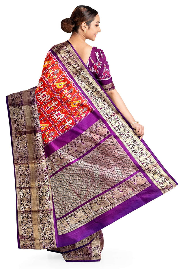 An orange colour ikkat pure silk saree in narikunj  pattern .