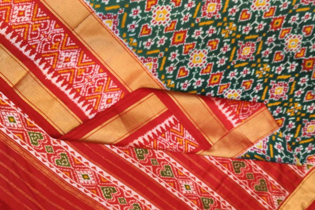 Ikkat pure silk saree in bottle green with a combo of navratan &  pan bhat pattern.