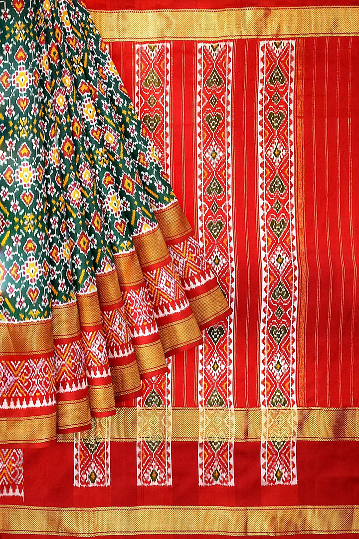 Ikkat pure silk saree in bottle green with a combo of navratan &  pan bhat pattern.