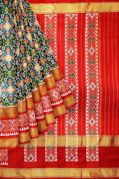 Ikkat pure silk saree in bottle green with a combo of navratan &  pan bhat pattern.