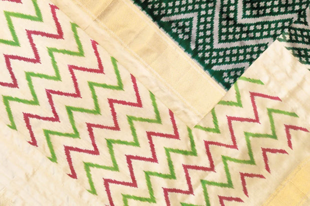 Ikkat pure silk saree in bottle green in zig zag pattern.