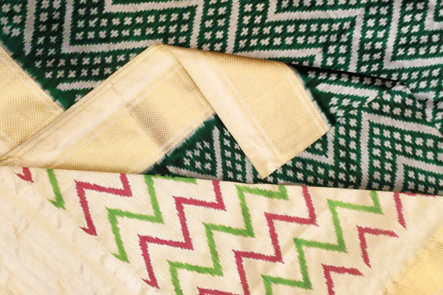 Ikkat pure silk saree in bottle green in zig zag pattern.