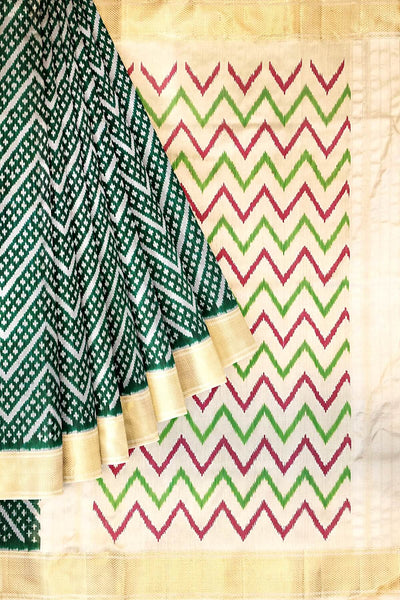 Ikkat pure silk saree in bottle green in zig zag pattern.