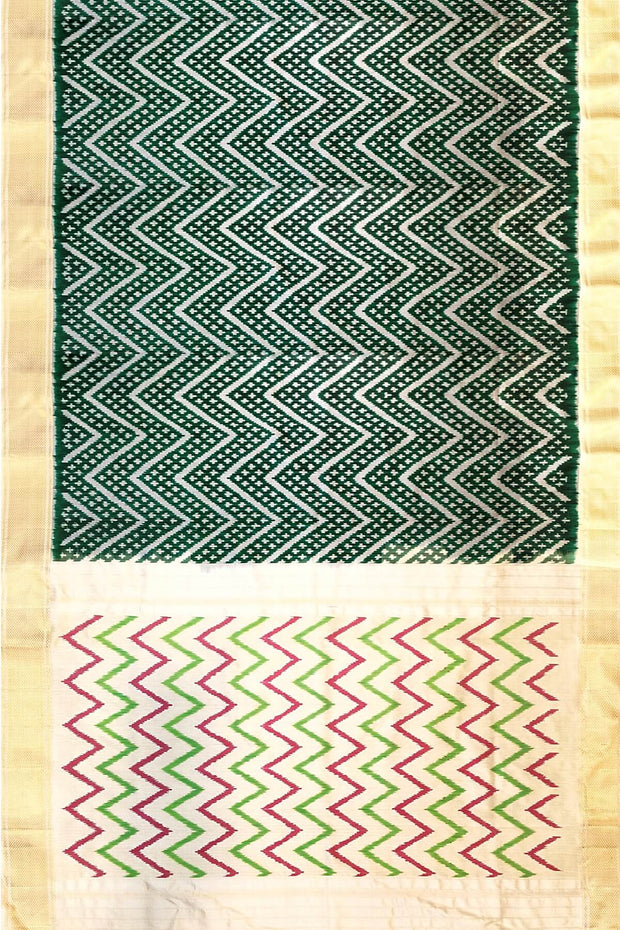 Ikkat pure silk saree in bottle green in zig zag pattern.