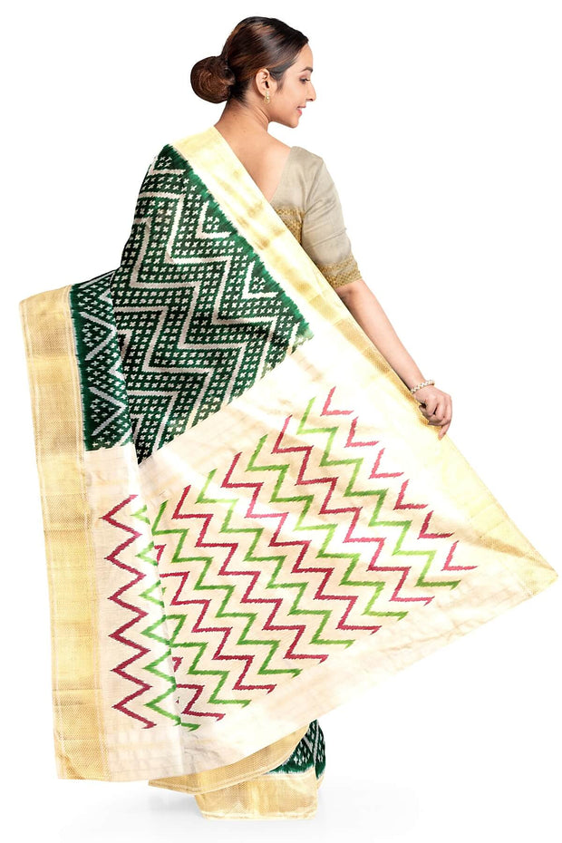Ikkat pure silk saree in bottle green in zig zag pattern.