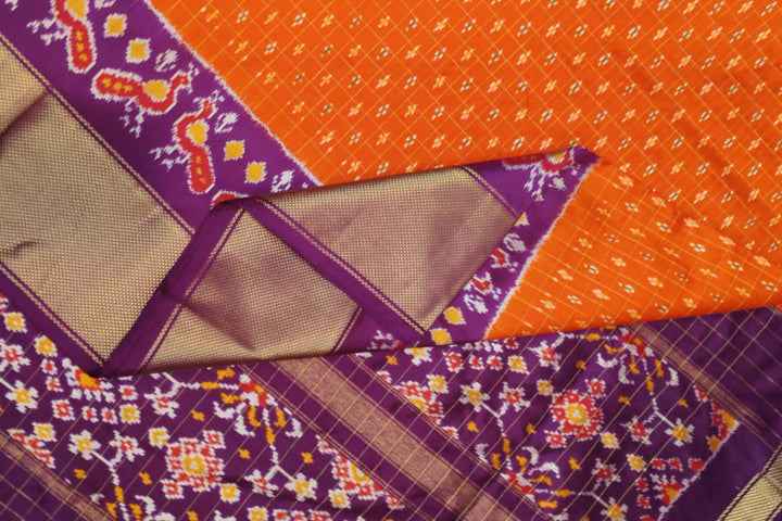Ikat pure silk saree in orange with zari checks .