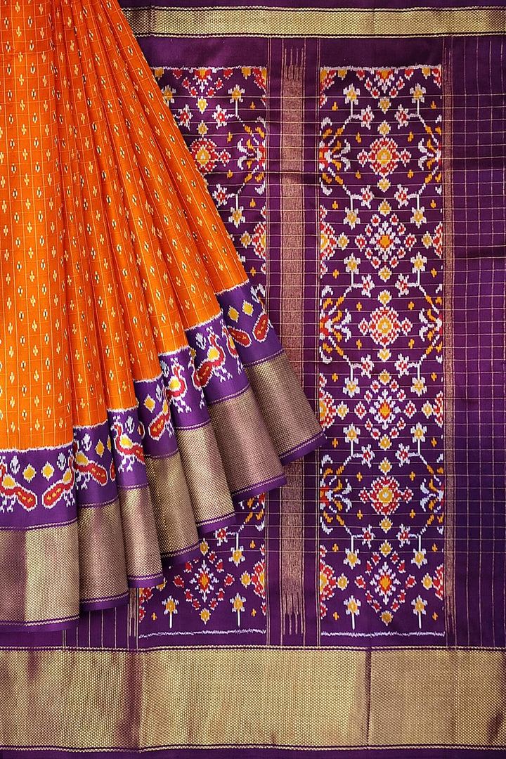 Ikat pure silk saree in orange with zari checks .