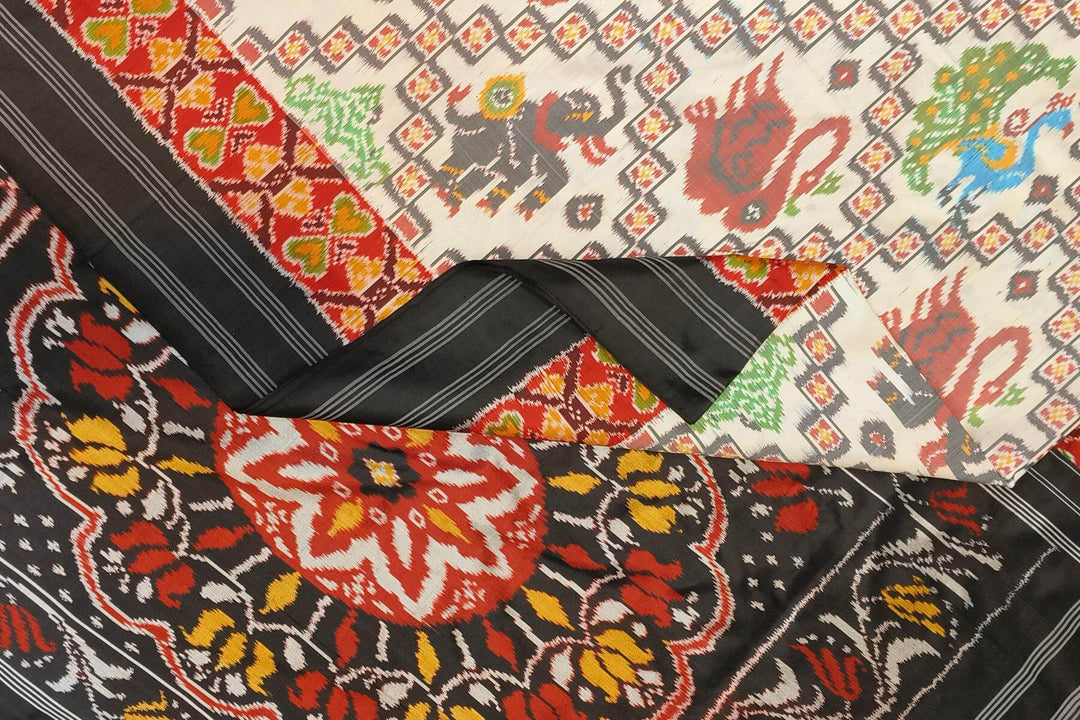 Ikkat pure silk saree in off white with birds & animal motifs.