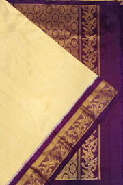 Handwoven Kanchi pure silk saree in off white and a contrast pallu in purple.