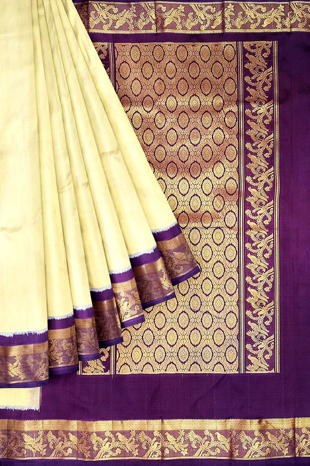 Handwoven Kanchi pure silk saree in off white and a contrast pallu in purple.
