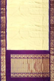 Handwoven Kanchi pure silk saree in off white and a contrast pallu in purple.